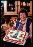 Julia Child holds cake commemorating 10th anniversary of KUHT Channel 8's Auction