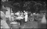 Group of people near table with food