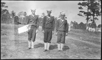 Three sailors at attention