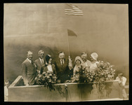 Mary Ellen Bute (maid of honor), Elisabeth Holcombe (ship's sponsor), and Charlotte Williams (special guest) on platform with special guests at USS Houston (CA-30) launching ceremony