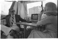 Carrie Nye and man sit in RV