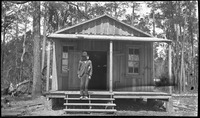 Man on steps of wooden building