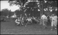 Several people sitting on a wooden bench