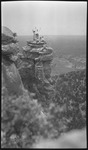 Group of people atop a tall rocky outcrop