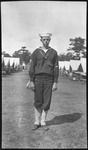 Man in sailor's uniform between tents
