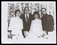 Mary F. Lopez standing with three people