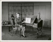 Woman displays sketch of palm tree at drawing desk