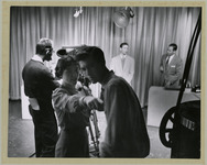 View of Guy Checkert, Sarah Beach, and Bill Slater working behind the scenes