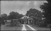 Front view of a house surrounded by trees