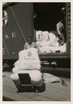 Worker transporting sacks of flour
