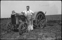 Man standing next to a tractor
