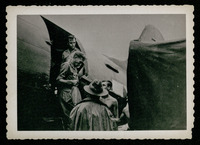 Men exiting plane, evacuation of POWs
