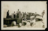 Crew dockside with Cubans watching