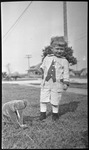 Boy posing with toy elephant
